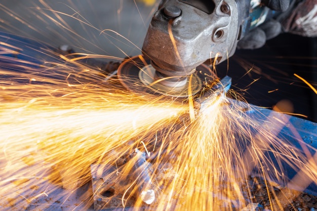worker-cutting-steel-with-grinding-machine-splashes-sparks-workshop_53283-206